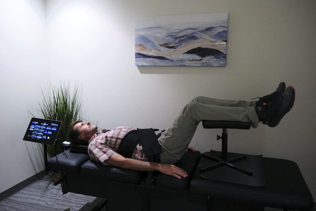 A Tangelo client demonstrates spinal decompression in lieu of back surgery at Tangelo.
