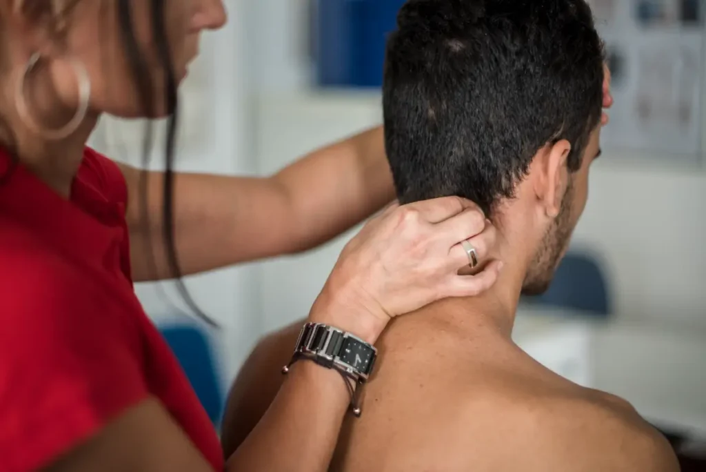 Chiropractor in Seattle guiding a patient through shoulder mobility exercises during pinched nerve treatment at Tangelo Health.