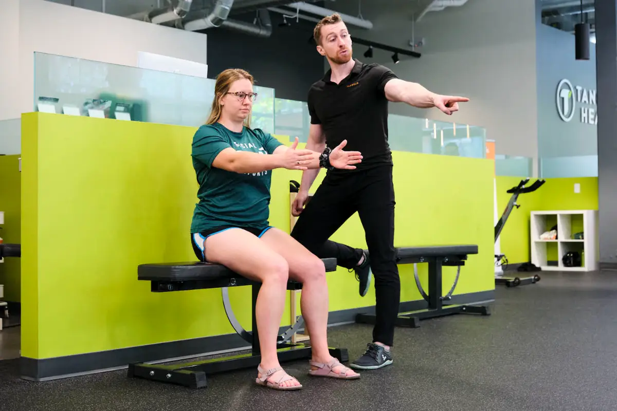 Tangelo Health chiropractor showing a patient proper posture and alignment during functional rehabilitation for a pinched nerve in Seattle. Tangelo Health chiropractor showing a patient proper posture and alignment during functional rehabilitation for a pinched nerve in Seattle.