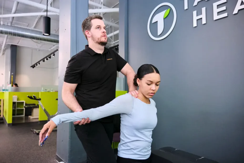 Chiropractor applying gentle neck treatment to relieve nerve compression and improve mobility for a patient in Seattle.