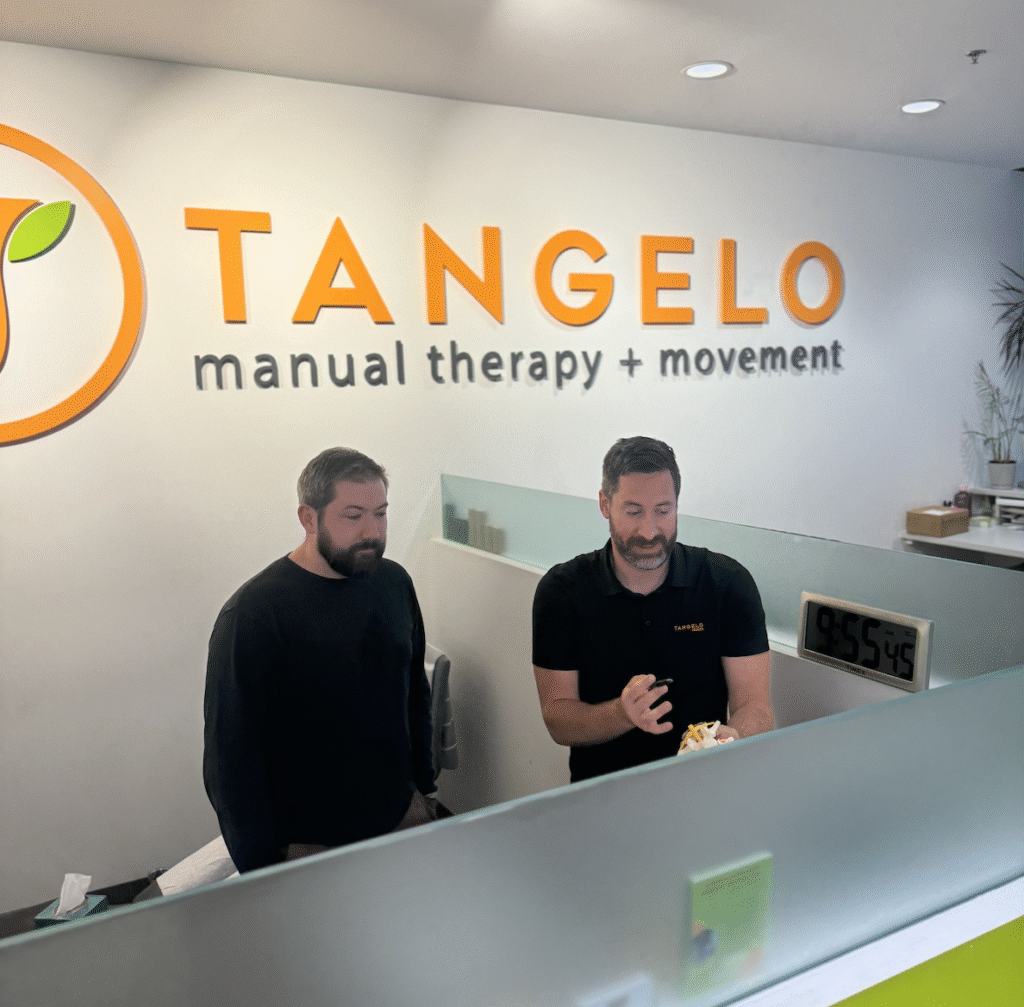 Chiropractors at Tangelo reviewing data.